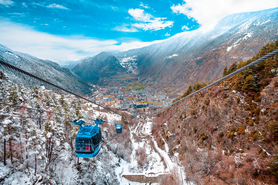 Encamp town in Andorra and cable car for lifting skiers and snowboarders to the top of the mountain